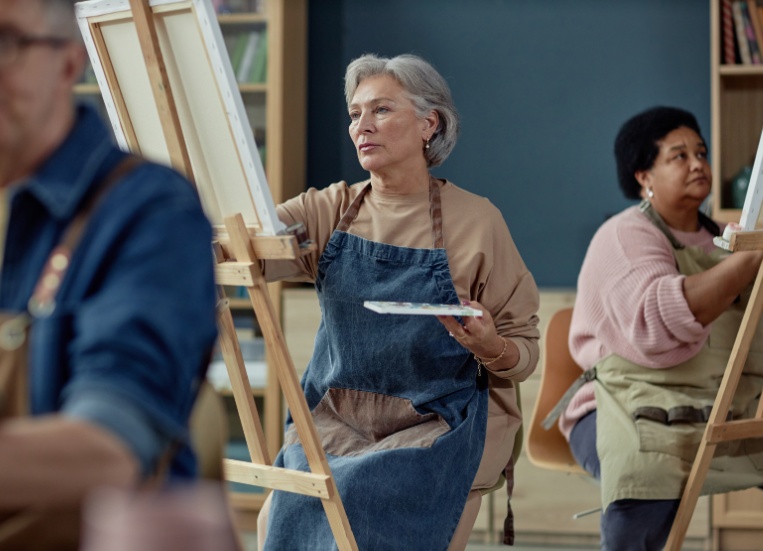 A group painting on easels in an art studio.