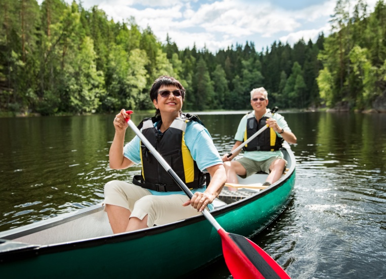 A couple on holiday taking a canoe ride.