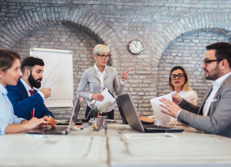 A group of colleagues sitting around a conference table.