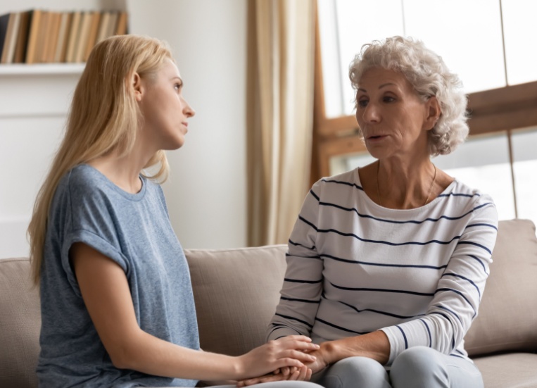 A mother and adult daughter talking.