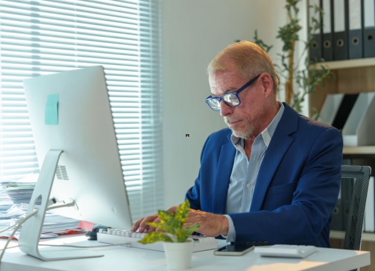 A man working at an office desk.