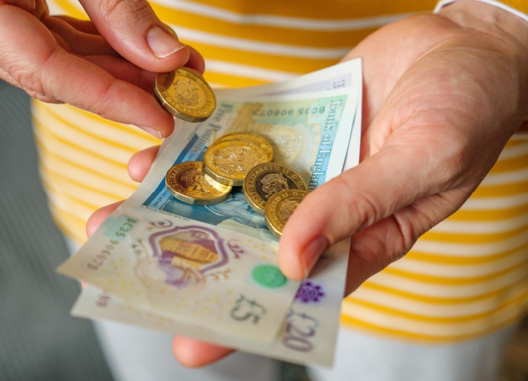 A woman holding cash in her hands.